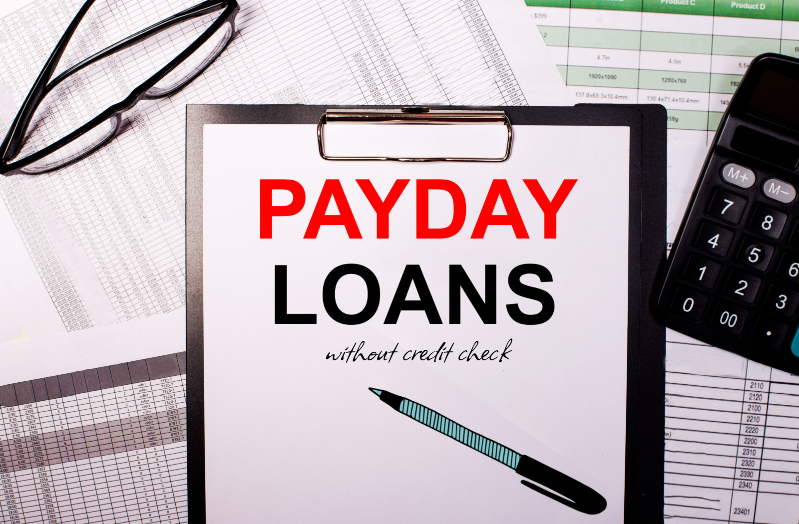 A white paper on a clipboard with "Payday Loans' worded on it.