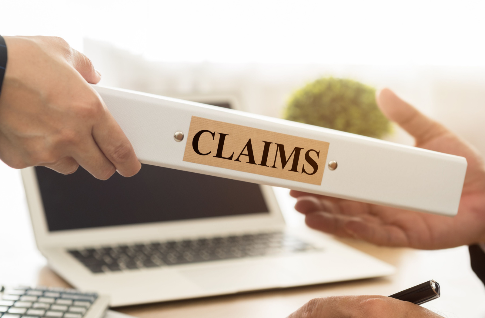 Close-up of a man's hands handling a claim document