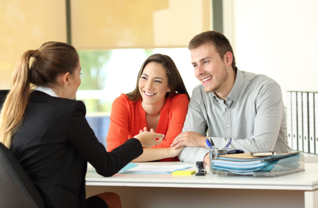 A man and a woman getting financial advice from a female loan officer.