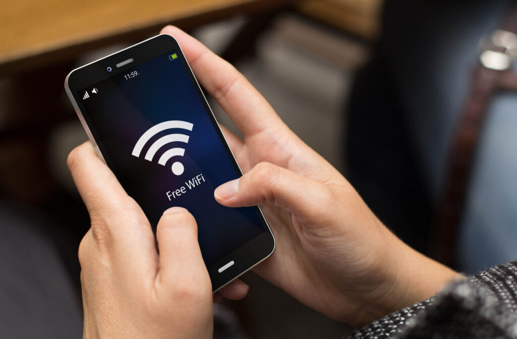 A woman using her smartphone to connect to a public Wi-Fi
